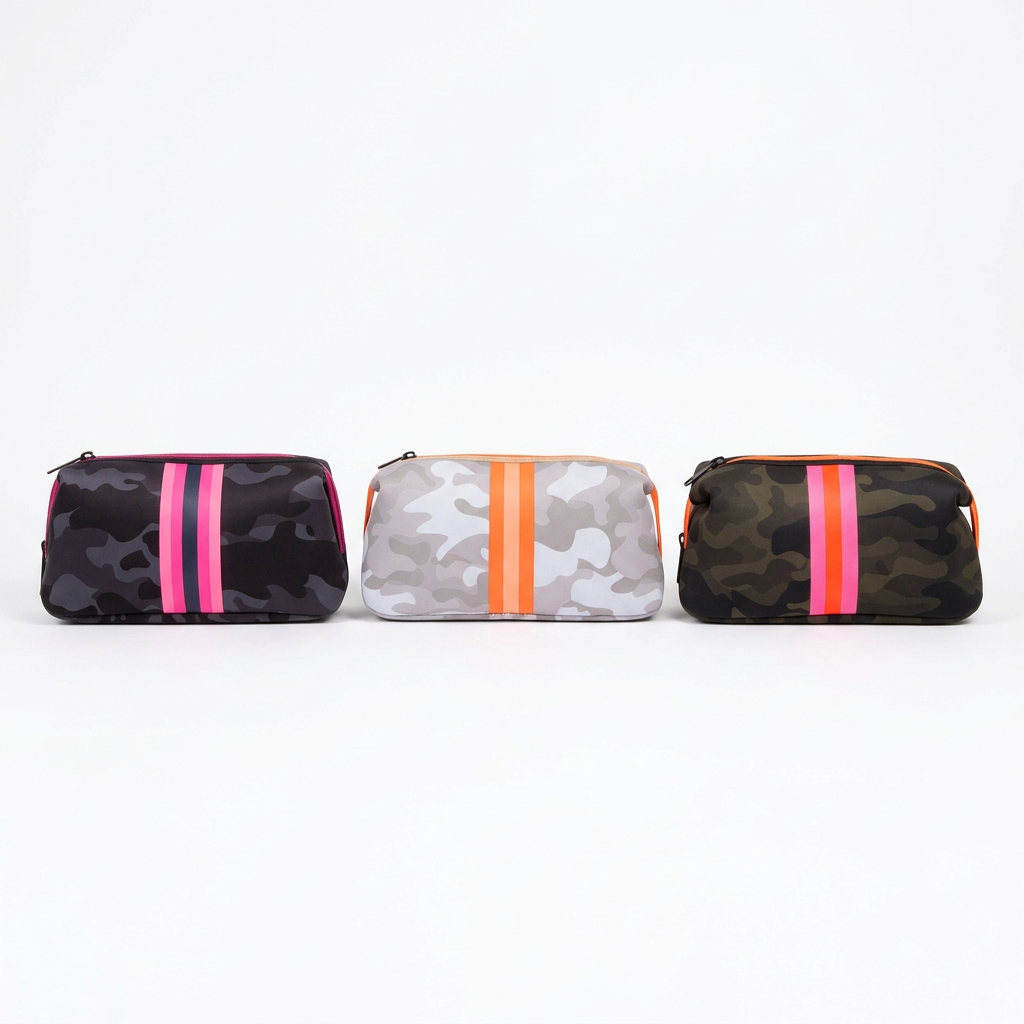 Three Kyle camouflage toiletry bags side by side with vertical pink and orange stripes